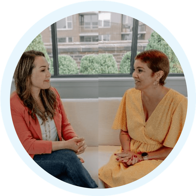 Two Latina women in a one-on-one bilingual coaching session, focused on emotional well-being, life transitions, and personal growth